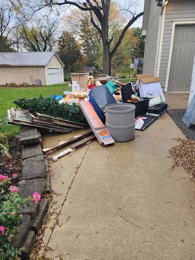 Dumpster being loaded with debris for 3 Yard Dumpster Rental in Prairie du Chien